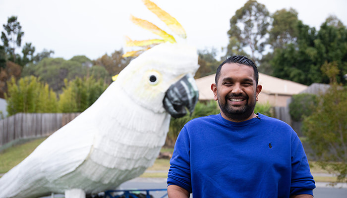 Dr Dinesh with giant cockatoo from Carnival of Joy